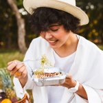 Portrait Of Beautiful Smiling Girl In Hat And White Shirt Eating 1.jpg